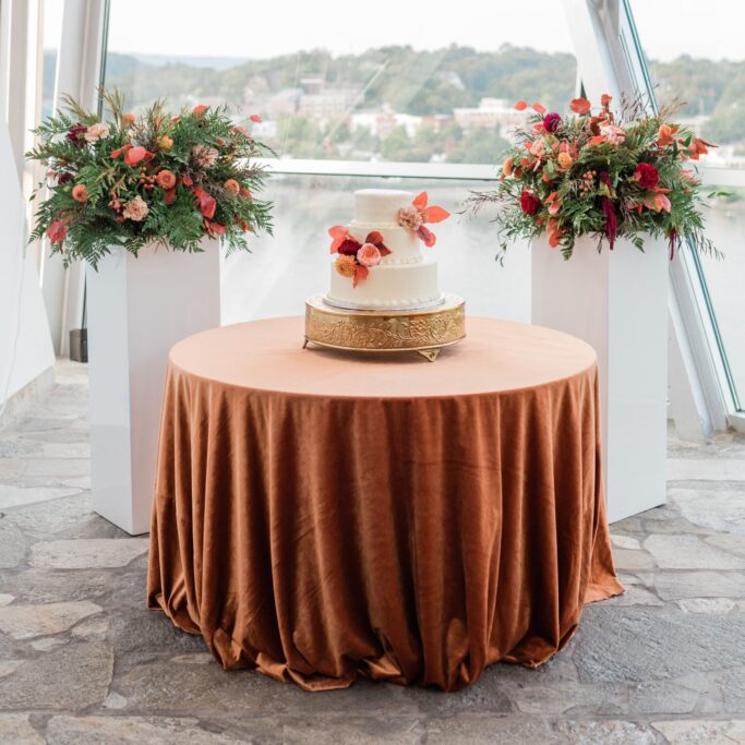 table with bronze tablecloth and flowers
