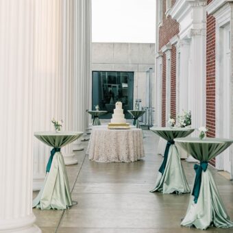 tall tables with green linens at outdoor event